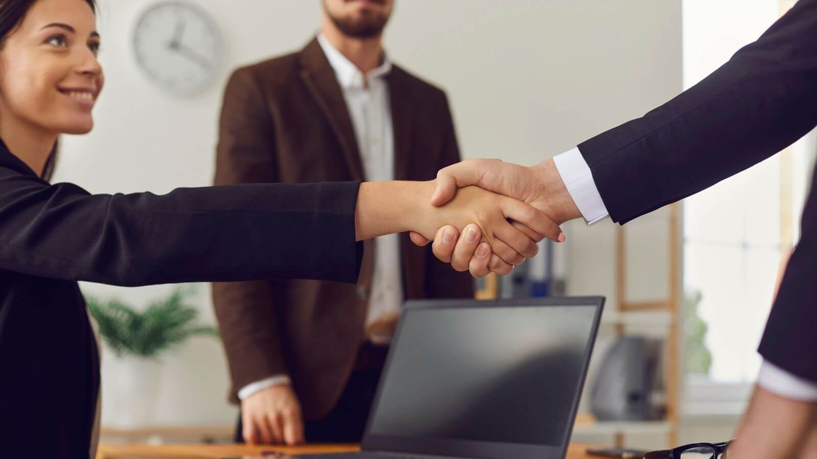 two people shaking hands after a negotiation